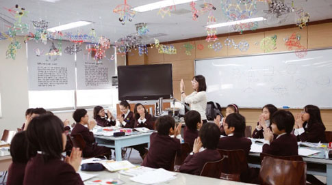 지곡초 4학년 수학반 학생들이 창의실에서 양손을 모으며 수학동아 12월호에 나온 ‘거울면 대칭’을 실험하고 있다.